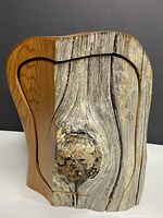Front view showing natural bark facade and carved outline of removable lid