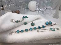 Group shot of all jewelry pieces on white cloth