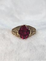 Front view showing oval synthetic ruby set in gold