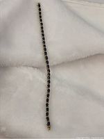 Full length view of sapphire and diamond bracelet laid on white background