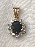 Front view of deep blue oval sapphire surrounded by diamonds