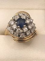 Front view showing central sapphire and surrounding diamond cluster