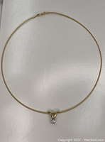 Full view of the gold choker with pendant laid flat