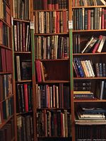 Bookshelves filled with various hardcover books across multiple subjects