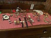 Overview of all watches and jewelry displayed on a red cloth