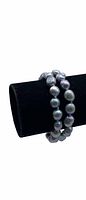 Double layered blue baroque pearl bracelet displayed on black velvet bracelet holder showing pearl arrangement and sheen.