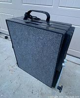 Dog ramp folded compactly showing handle and carpeted surface