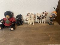 Overview of the seven figurines including felted mice, teddy bear, black Ty black lab, and flower girl knickknack.