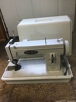 Off-white Mini Brute industrial sewing machine with removable base and optional hard plastic carrying case