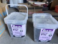 Blurry image of same two boxes of Builder Rock-On screws.