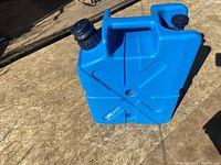 Front-angle view of blue plastic jerry can with dual caps and embossed cross pattern
