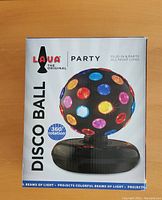 Photo of the Lava brand original party disco ball light on box showing colorful circular lenses and 360 degree rotation feature.