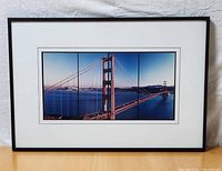 Framed Golden Gate Bridge photograph with white mat and black frame.