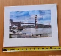 Full view of the 14 x 10 inch matted collage print depicting the Golden Gate Bridge with measuring tape showing size.