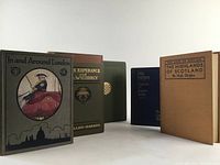 Front side angled view of 5 early hardcover books with varying colors and visible titles
