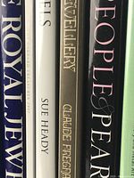 Close-up view of spines showing titles and authors of 5 jewelry books including 'The Royal Jewels', 'Jewel Sets', 'Jewellery', and 'People & Pearls'.