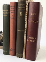 Five book spines lined up: dark green 'Canada's Greatest Need' (S.P.G.); rust 'A History of the Canadian People' (Wallace, The Copp Clark Co.); dark olive 'Canada and the Canadian Question' (Goldwin Smith); beige softcover 'Travels in Lower Canada' (Coles Canadian Collection); burgundy 'Life in Canada' (Thomas Conant).