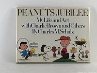 Front cover of the book featuring Peanuts characters and title.