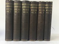 Front view of all six volumes of the set showing spines with gold embossed title 'Milman's Gibbon's Rome Vol. I - VI' and Boston imprint at bottom