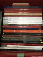 View of stacked approx 21 Sotheby’s and Christie’s auction catalogs focused on Latin American art with visible titles and sale dates