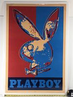 Front view of a large poster with the Playboy rabbit head image in red and blue with a 'PLAYBOY' text below.