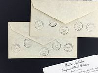 Three envelopes showing multiple postal cancellation marks on the back dated June 1977
