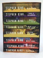 Pictorial slipcase spine edge showing the titles and author name in colorful bands representing each book in the set.