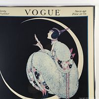 Framed Vogue vintage poster showing the woman sitting on a crescent moon against a black background with soft pink and blue floral details.