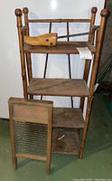Full view of bamboo shelving unit with shoe stretcher on top shelf and washboard propped on floor.