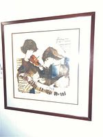 Full view of framed wall art showing two musicians and visible frame crack.