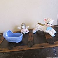 All three pottery nursery items displayed together on wooden surface, showing scale and condition.