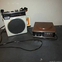 Lloyds 8 track player and speaker with Lloyds branding and control dials visible on top.