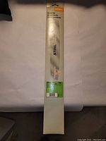 Full view of the Stihl chainsaw guide bar in white packaging, showing the 'Stihl' brand and 'Guide bar' text.