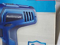 Close-up of Mastercraft logo on blue cordless drill casing.