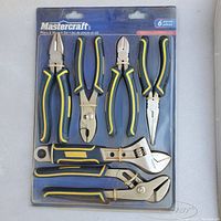 Photo of Mastercraft 6-piece pliers and wrench set in original packaging with blue background. The tools have ergonomically designed black and yellow handles for high visibility.