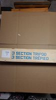 Cardboard box labeled '3 SECTION TRIPOD 3 SECTION TREPIED'