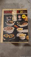 Box cover photo showing the front of the vintage Dynaware 20-piece oven and microwave safe set with images of the contents on the box.