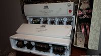 Dept 56 train village accessories boxed sets in original styrofoam packaging showing 'Elgin & Eight Tiny Reindeer' and 'The Flying Scot Train' labels and miniature train cars.