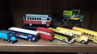 Display of all die cast buses, toy trucks and delivery vehicles on a shelf