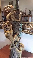 Side view showing three ceramic monkeys climbing the tree trunk lamp base