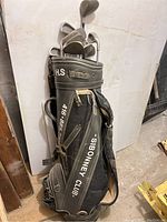 Golf bag standing upright showing Sibonney Club branding and shoulder strap.