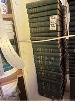 Stack of green hardcover Canadian Abridgement law books tied together, showing volume numbers and gold embossed text.