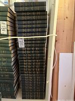 Full stack of 38 volumes arranged vertically on shelf