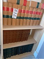 Full set of 35 Ontario Reports law books arranged on wooden shelves in beige covers with red and green spine bands.