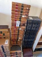 Overall display of the collection of Ontario Weekly Notes law books stacked vertically and horizontally showing their worn brown and blue leather bindings with volume numbers and years.