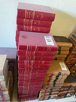 Set of over 30 red Ontario Reports Second Series law books stacked vertically showing volumes with gold embossed text on spine.