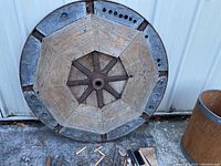Heavy constructed flywheel with wooden and metal parts, approx. 32 inch diameter