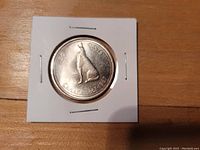 Reverse side of coin showing wolf and 1967 Centennial markings