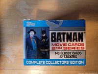 Front view of the sealed box showing Batman and Joker characters, 2nd series label, and number of cards and stickers included.