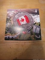 Front of display folder featuring the 2015 Canadian silver coin with Canadian flag.
